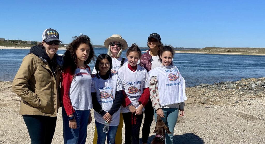 Student participants in beach clean up and their mothers