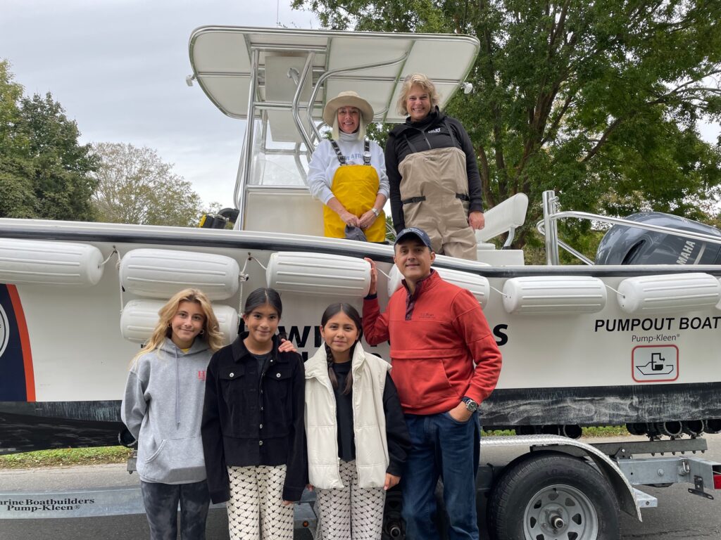 EH Anniversary Parade 10/14/23 Trustees Susan McGraw-Keber and David Cataletto with his students and members of EH Middle School's Surfrider Junior Club - Southampton Town Trustee Ann Welker on Trustees Pump Out boat.