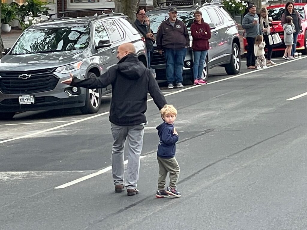 Councilman David Lys and a young friend marching along in the parade