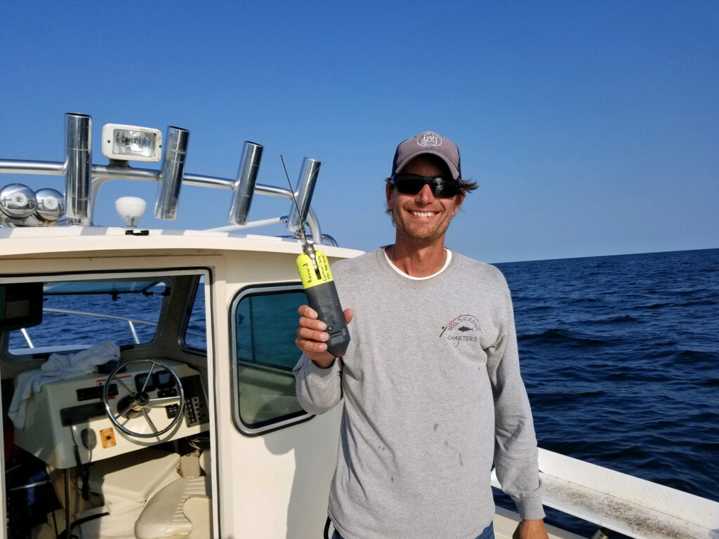 Dan's Papers 2019 Southampton High School marine biology teacher Greg Metzger proudly displays a CATS-cam tag placed on the first thresher shark he caught after it was retrieved.