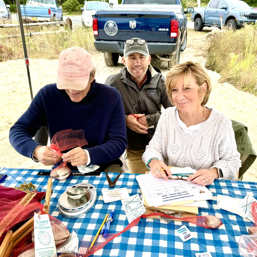 Trustee John Aldred, Director of the Department of Natural Resources, Kim Shaw, and Director of the East Hampton Shellfish Hatchery, John "Barley" Dunne weighing and measuring the clams...who found the largest clam?