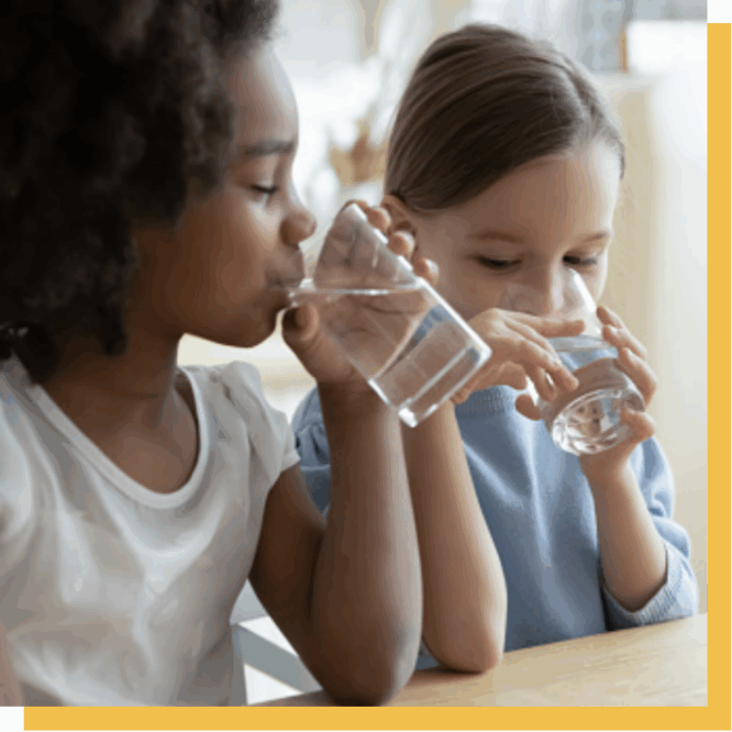 Children drinking water from glasses